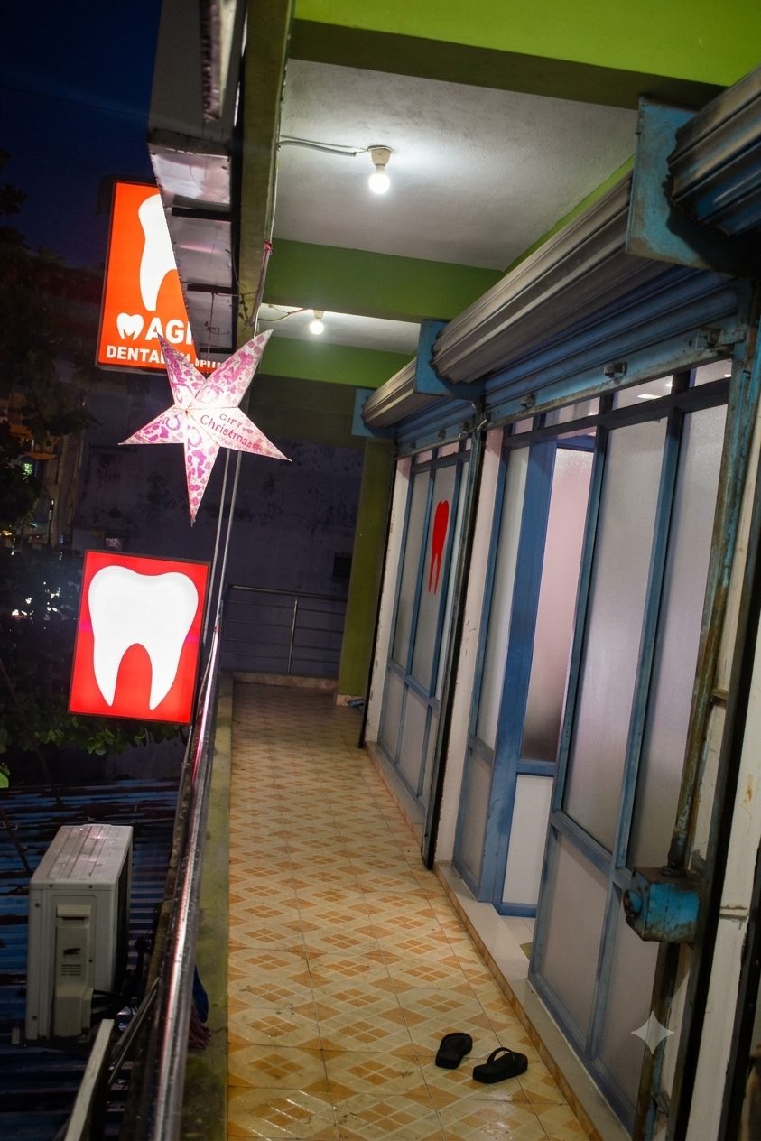 Magna Dental Clinic entrance corridor with frosted glass and tooth logo at Tiruvottiyur