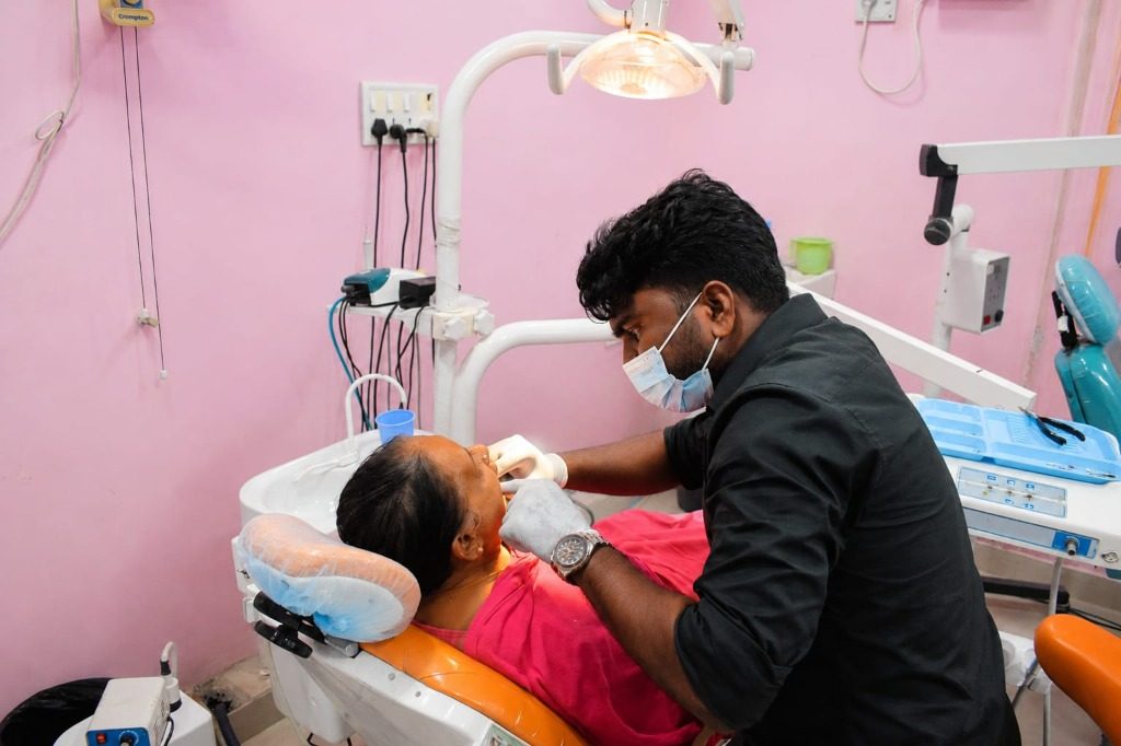 Dr. Jemison Paul examining a patient at Magna Dental Clinic