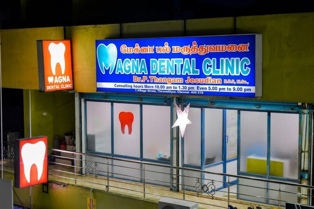 Magna Dental Clinic illuminated signboard at night in Tiruvottiyur